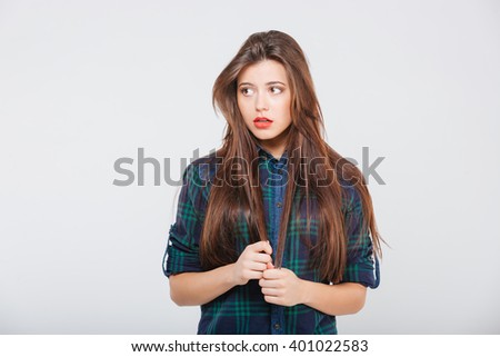 Pensive casual woman looking away isolated on a white background