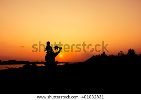 silhouette of dad and son play plane sunset background