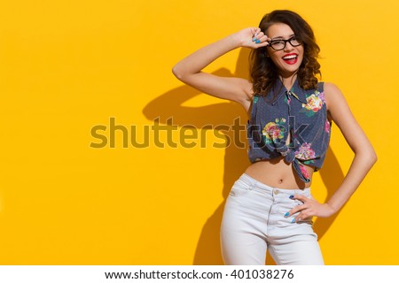 Shouting Girl In Glasses Posing In The Sunlight On Yellow Background Royalty-Free Stock Photo #401038276