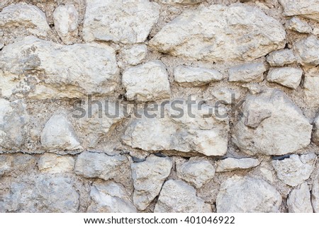 The texture of the stone wall of white and gray color. It can be used as background