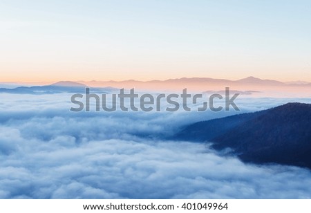 A great view of the foggy hills glowing by sunlight at twilight. Dramatic and picturesque morning scene. Location place: Carpathian national park, Ukraine, Europe. Artistic picture. Beauty world.