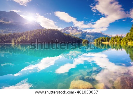 Fantastic view of the azure pond Champfer. Picturesque scene. Location: resort Silvaplana village, district of Maloja in the Swiss canton of Graubunden, Alps. Europe. Artistic picture. Beauty world.