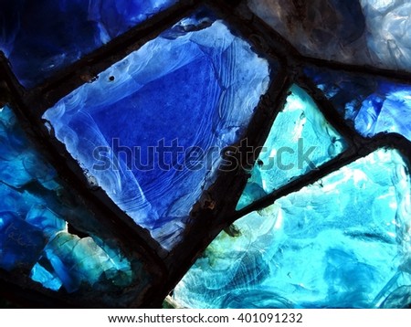Close up of broken blue stained-glass window.