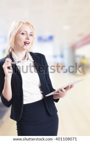 Portrait of young pretty woman holding tablet computer and glasses smiling 