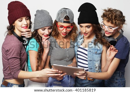 lifestyle and people concept: five hipster girls friends taking selfie with digital tablet, studio shot over gray background