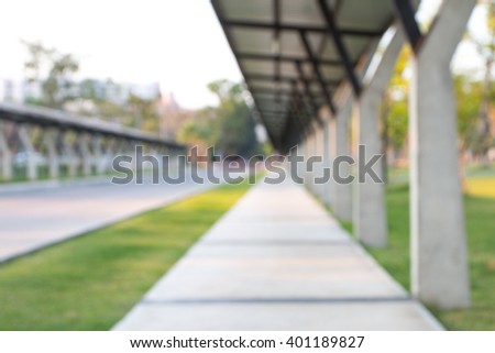 Blur or defocus picture of university road and walkway with roof that for use as background