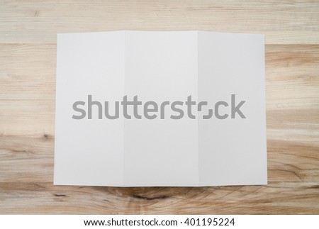 Trifold white template paper on wood texture