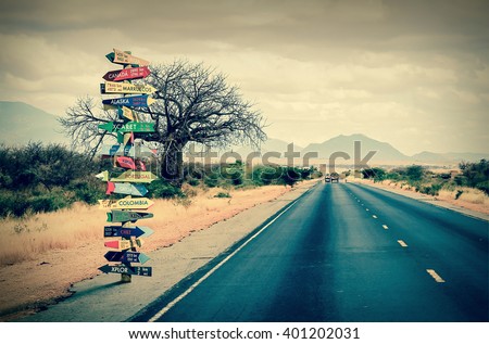World directions signpost with distance to many different countries Royalty-Free Stock Photo #401202031