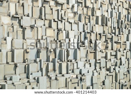Facade of broken granite tile wall.
