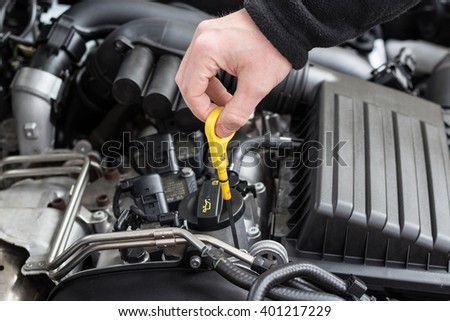 check the oil  in modern car motor  Royalty-Free Stock Photo #401217229