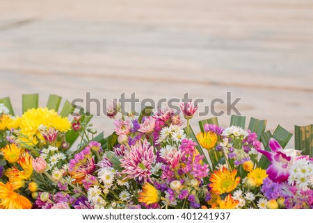 Beautiful flowers made on soft wooden background