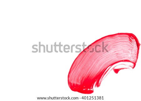 Red lip gloss on a white background close-up.