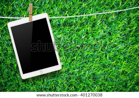 Hanging blank digital tablet computer with isolated screen with clipping path.
