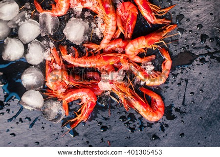 fresh raw shrimps on a black board

