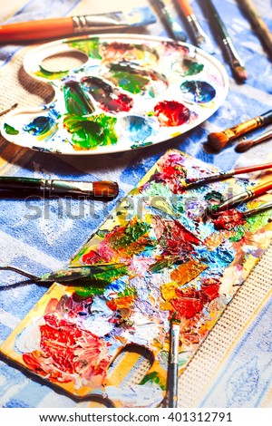 Colourful oil paint, different types of brushes and palette