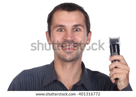 Young bearded man during grooming of beard using trimmer