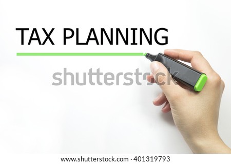 Hand writing tax planning with green marker on transparent wipe board.