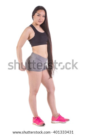 Beautiful fitness oriental woman standing - isolated over a white background