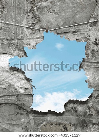 Close-up of one hanged France silhouette frame with sky against stone wall background