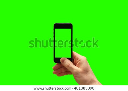 Hand holding smartphone and taking photo on greenscreen background. (Put your own photo behind and inside the phone)