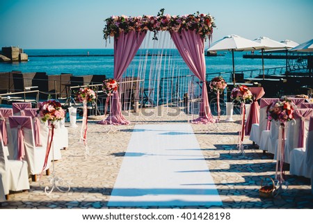 Beautiful delicate wedding aisle on beach Royalty-Free Stock Photo #401428198