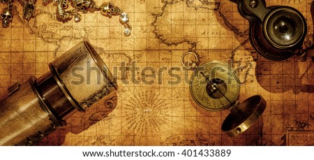Old vintage retro compass and spyglass on ancient world map. Vintage still life. Travel geography navigation concept background.