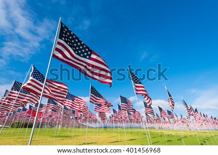 A field of hundreds of American flags.  Commemorating veteran's day, memorial day or 9/11. Royalty-Free Stock Photo #401456968