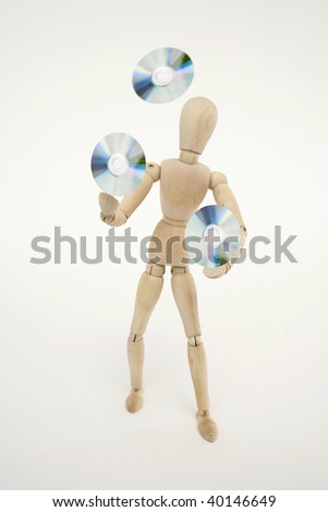 Jointed doll juggling with cds, isolated on white background