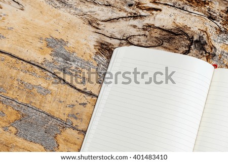 Open notebook on wood background.
