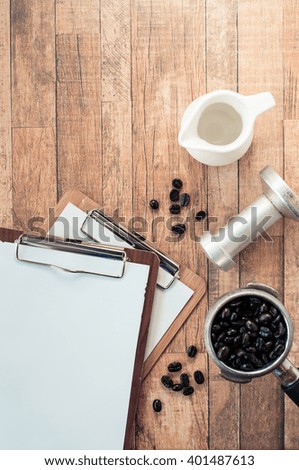 blank clipboard over wooden table next to coffee cup . ready for adding text. retro filtered image