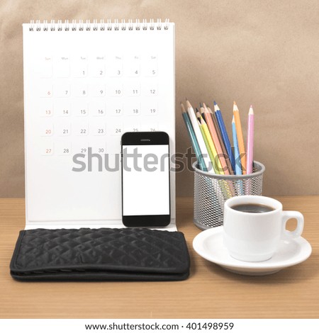 office desk : coffee with phone,calendar,wallet,color pencil on wood background