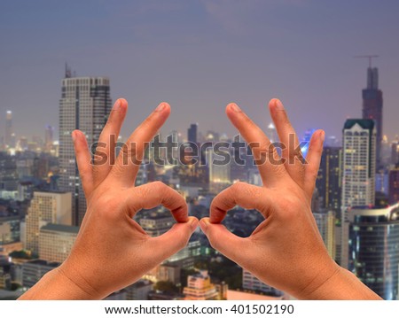 all Okay hand sign on on blurred city Landscape background
