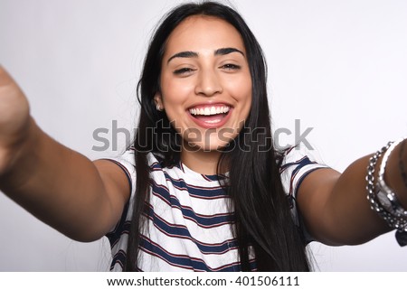 Close-up of young beautiful woman taking selfie. Isolated white background Royalty-Free Stock Photo #401506111