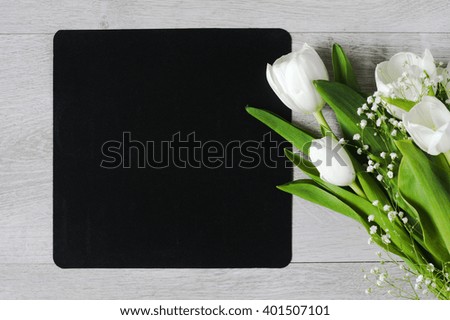 White tulips and chalkboard on grey background, copy space for text. Flat lay, top view