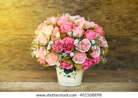 Plastic flowers with wooden background in vintage picture style, home interior equipment, Flowers set on wooden background. Hand made.