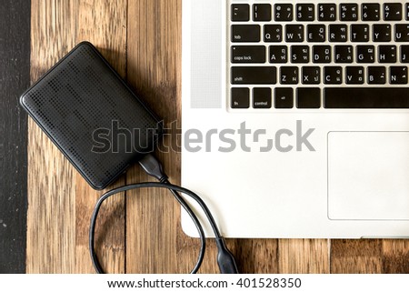 External hard disk and laptop computer, with selective focus