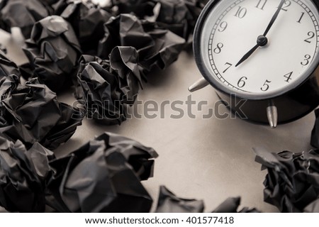 alarm clock with black paper balls on floor