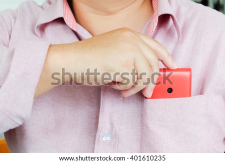 Smart phone in a shirt pocket of a business man