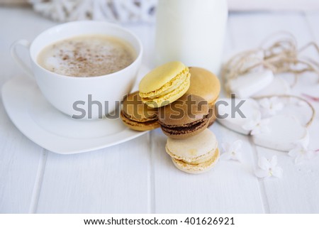Coffee, macaroons and milk  on a white table