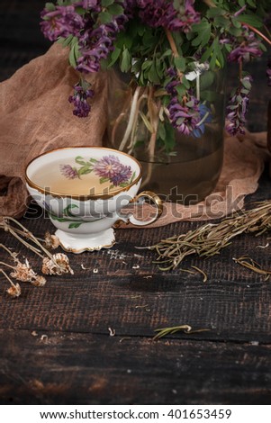 Tea with  lemon and bouquet of primroses on the table