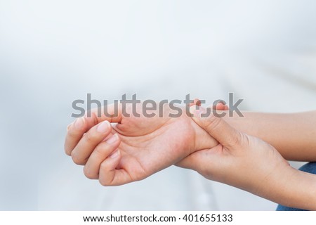 Close up woman holding her wrist symptomatic Office Syndrome