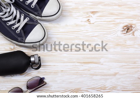 still life with sneakers, sunglasses and perfume