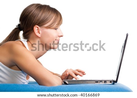 Happy young girl chatting using her laptop. Isolated white background