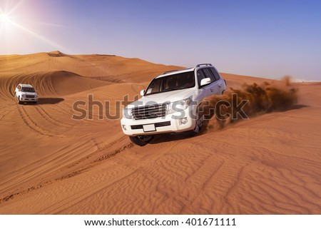 Desert Safari SUVs bashing through the arabian sand dunes Royalty-Free Stock Photo #401671111