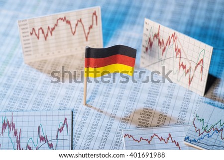 German flag with rate tables and graphs for economic development. Royalty-Free Stock Photo #401691988