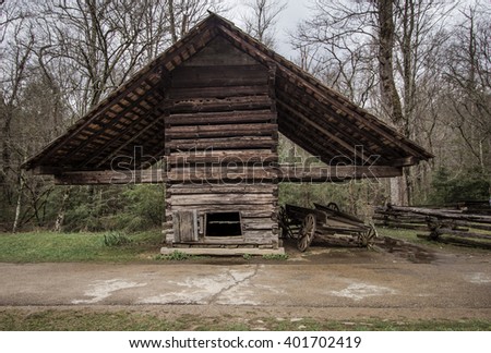 Agriculture Vintage Style Background. Corn crib and covered wagon outside a historical 18th century outbuilding. This is a public owned building in a national park and not a privately owned residence.