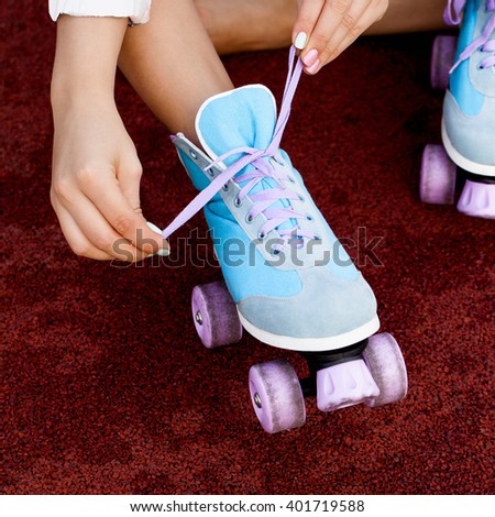 Leg of young woman with roller skate on it. Outdoors lifestyle portrait