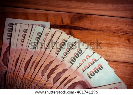 a lot of money on wood background. - Vintage Tone.