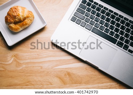 Working place with laptop on wooden background