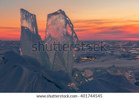 Transparent ice on sunset sky background